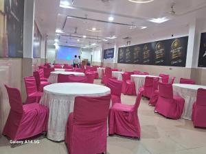 a room with pink and white tables and chairs at KING'SWAY Hotel & Resort in Dūngarpur +44 photos