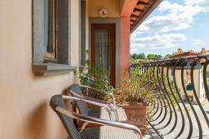 a row of chairs on a balcony with plants at Locanda Il Gallo in Greve in Chianti