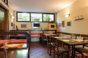 a restaurant with tables and chairs and a window at Locanda Il Gallo in Greve in Chianti +21 photos