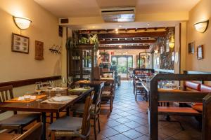 a dining room with wooden tables and chairs at Locanda Il Gallo in Greve in Chianti