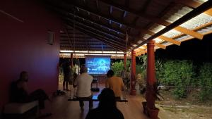 a group of people playing a video game on a screen at Aksha Homestay in Sakleshpur