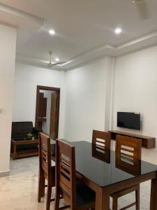 a dining room with a table and chairs at Dream Castle in Cochin