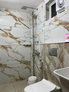a bathroom with a shower and a toilet and a sink at Dream Castle in Cochin