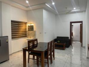 a kitchen and dining room with a table and chairs at Dream Castle in Cochin