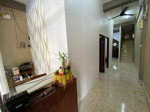 a hallway with a table with a yellow table cloth at Ibu ana quest house in Tabanan