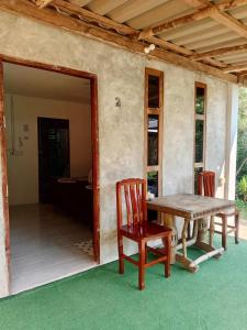 a table and chairs on the porch of a house at Lung peiyk homestay in Ban Bang Bao