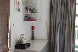 a tea kettle sitting on a table in a room at Mukuku Oasis Lodge in Shimweghe