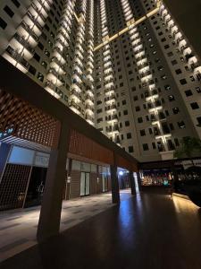 a large apartment building with a large building at Osaka Riverview Apartment PIK 2 in Rawalumpang