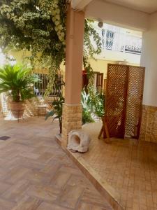 a courtyard with a pillar and plants in a building at Mediterranean in Preveza