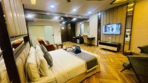 a hotel room with a bed and a television at HOTEL JD HEAVENS in Jhajjar
