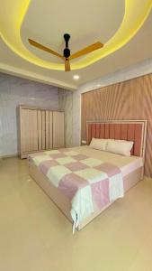 a bedroom with a large bed with a ceiling at Shubh causy 4bhk villa in Lonavala