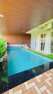 a swimming pool in the middle of a house at Shubh causy 4bhk villa in Lonavala