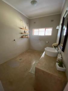 a bathroom with a tub and a sink at Mon Desir Estate - BR4 in Pietermaritzburg
