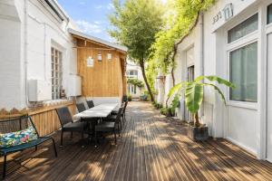 a patio with a table and chairs on a building at Cit' Hotel de France in Rochefort +27 photos