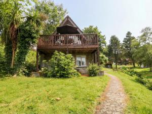 a house with a deck on top of a field at Lavender Lodge in Callington