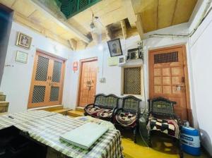 a room with chairs and a table in a room at The Jeet Mahal Hotel in Jaisalmer