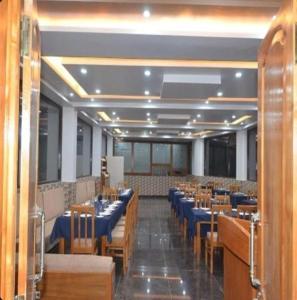 a dining room with blue tables and chairs at The Jeet Mahal Hotel in Jaisalmer +19 photos
