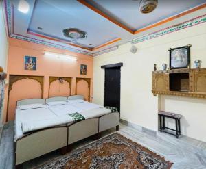 a bedroom with a bed and a fireplace at The Jeet Mahal Hotel in Jaisalmer