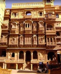 a large building with alot of windows and a scooter in front at The Jeet Mahal Hotel in Jaisalmer