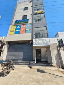 a building with a motorcycle parked in front of it at Hotel Yashoday in Kekri