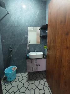 a bathroom with a sink and a mirror and a toilet at Hotel Yashoday in Kekri +9 photos