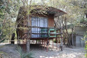 a tree house in the middle of a forest at Mukuku Oasis Lodge in Shimweghe