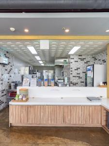 a large kitchen with a counter in a restaurant at Yangji Resortel in Hwaseong