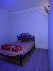 a bedroom with a bed in a dark room at شقق الخيالي 1 in Tan-Tan
