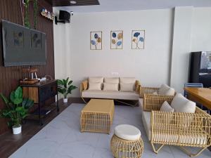 a living room with a couch and a flat screen tv at Maywood Private Resort in Calamba