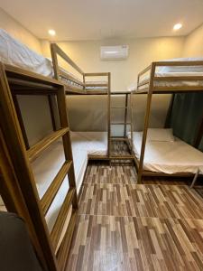 three bunk beds in a room with a wooden floor at Maywood Private Resort in Calamba +26 photos