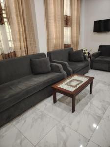 a living room with a couch and a coffee table at Charlotte Inn in Kandy