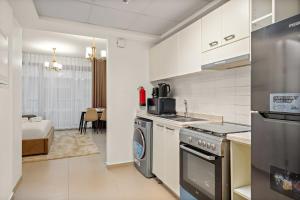a kitchen with a sink and a stove top oven at FIRST CLASS Studio Pacific Shores Retreat in Ras al Khaimah