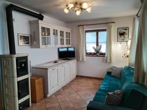 a living room with a blue couch and a tv at Casa vacanze tortoi in Candide