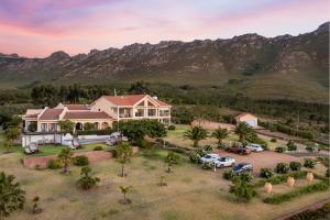 an aerial view of a house with a parking lot at Apricot Gardens Guesthouse in Gordonʼs Bay