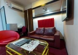 a living room with a couch and a table at Lazdana Hotel Kuala Lumpur in Kuala Lumpur