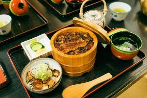 a tray of food on a table with a plate of food at キュリナリーBed and Art in Hamamatsu