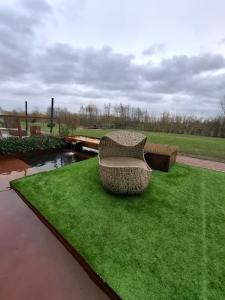 a bench sitting on the grass in a park at B&B Finis terrae with wellness in Lokeren