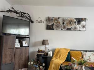 a living room with a couch and a tv at Ubytovanie Dana in Piešťany