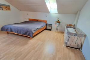 a bedroom with a bed and a wooden floor at Haus Probst in Bischofsmais