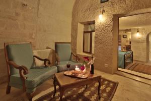 a living room with two chairs and a table at Jacob's Cave Suites - Cappadocia in Göreme