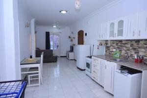 a kitchen with white cabinets and a counter top at Qasr El Nil in Luxor
