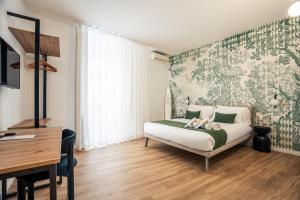 a bedroom with a bed with a green and white wallpaper at xenia apartments & suite in Syracuse +45 photos
