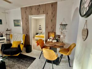 a living room with a table and chairs and a bed at Ubytovanie Dana in Piešťany