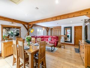 a living room with a table and a red couch at The Lodge in Gloucester