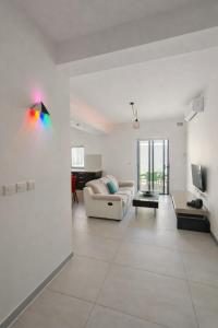 a white living room with a rainbow kite on the wall at Modern Double Room in Peaceful Pembroke just Minutes away from St Julians in Pembroke