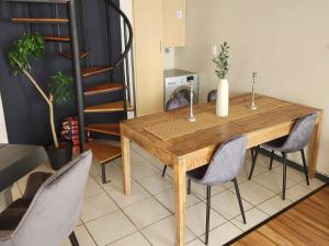a wooden table and chairs in a room at 13 at Santos in Mossel Bay +8 photos