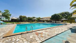 a swimming pool in a resort with umbrellas at MaTemu Square in Mapinga