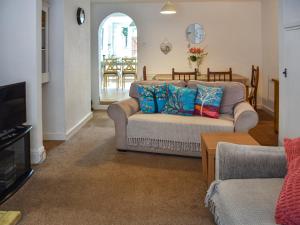 a living room with a couch and a table at Maydrift in Mundesley