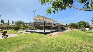 a pavilion in a park with a grass field at MaTemu Square in Mapinga