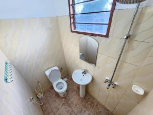 a bathroom with a toilet and a sink at MaTemu Square in Mapinga +40 photos